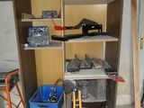 a shelf that has tools on it in a garage
