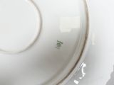 a white plate with a green design on it