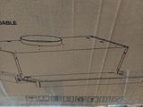 packaging of a microwave sitting on top of a cardboard box on the floor