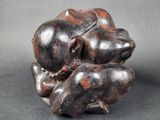 a close up of a sculpture of two mice on a black surface