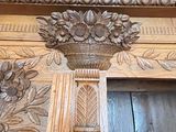 a vase of flowers on the top of a wooden door