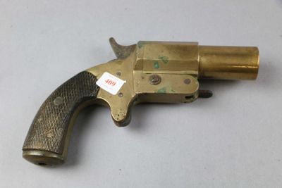an old brass revolver with a tag on it sitting on a table