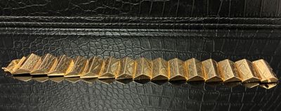 a close up of a black purse with a gold clasp