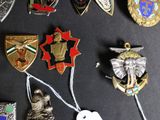 a lot of badges that are on a black surface