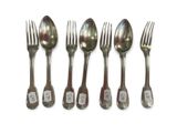 six forks and spoons are lined up on a white surface