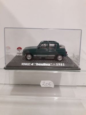 a small green car in a clear display case