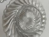 two empty glass dishes sitting on a white table
