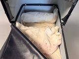 a black suitcase with a blanket inside of it
