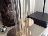 a table with a vase, candle holder, and other items on it