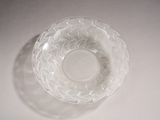a clear glass bowl on a table with a white background