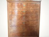 an antique chest of drawers with a wooden top and brass hardware