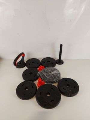 a lot of black dumbs and a pair of scissors on the table