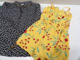 two dresses that are sitting on a white table