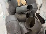 a pile of plastic pipes sitting on the floor