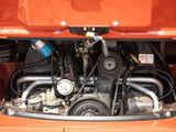 a close up view of the engine of an orange car