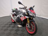 a motorcycle that is parked on a black and white checkered floor
