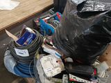 a pile of assorted items on a table in a warehouse