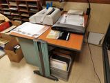 an image of a desk with a printer and other office supplies