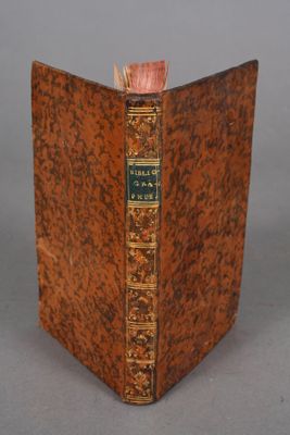an old book sitting on top of a table next to a gray background