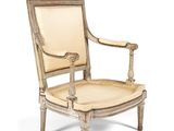 an image of a wooden chair with a beige upholstered seat