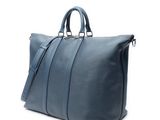 a blue leather duffel bag on a white background