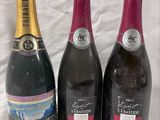 three bottles of wine sitting next to each other on a table