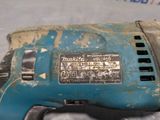 a blue drill that is sitting on top of a table