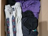 a box full of clothes that is sitting on the floor