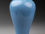 a blue vase that is sitting on a table
