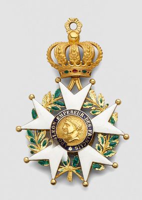 an image of a gold medal with a crown on top of it