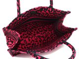 pink and black leopard print handbag on a white background