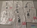 six white t - shirts with chinese characters on them sitting on a table