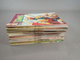 a stack of comic books sitting on top of each other on a table