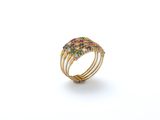 a close up of a gold ring with multi colored stones
