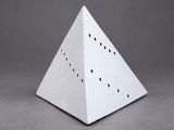 a close up of a white pyramid shaped object on a gray background