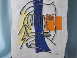 une peinture représentant le visage d'une femme sur une plaque blanche et bleue