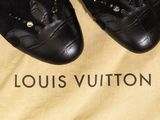 louis vuitton black leather shoes with gold buckles on a yellow bag