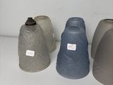 three vases sitting next to each other on a shelf