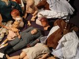 a lot of dolls that are sitting on a table