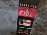 a shark sign on the side of a metal box