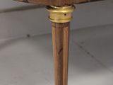 a wooden table with a brass plate on it