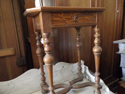 a small wooden table with a drawer on top of it