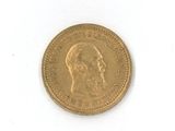 une pièce d'or sur laquelle figure le visage d'un homme