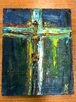 an oil painting of a cross on a wooden surface