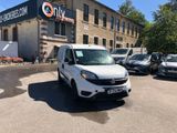 a white van parked in front of a building
