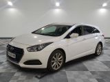 a white car is parked in a room with a checkered floor
