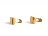 pair of gold plated cufflinks on white background