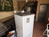 a refrigerator in the middle of a room with a table and chairs