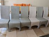 four chairs that are lined up in a row