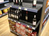 many bottles of wine on the shelves in the store